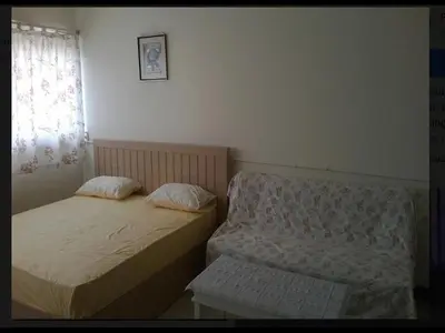 two beds in a small room with a window at T8 Guest House Don Mueang Challenger triple room in Ban Song Hong