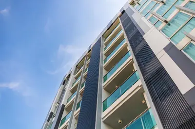 a tall building with a blue sky in the background at United Residence Ekamai Bangkok in Bangkok
