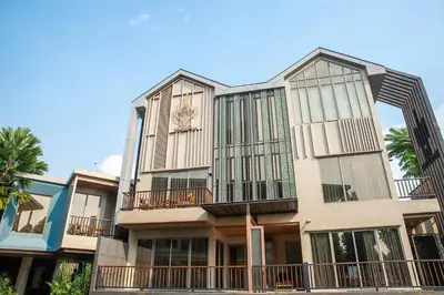 a building with a clock on the side of it at W1Bangkoknoi Hotel in Nonthaburi