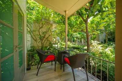 a patio with chairs and a table on a balcony at W1Bangkoknoi Hotel in Nonthaburi
