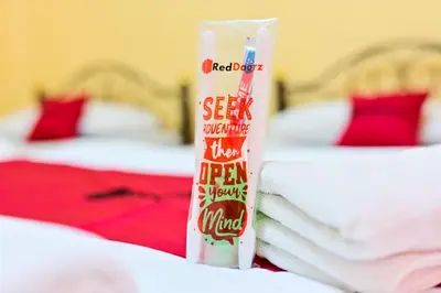 a bottle of red diaper sitting on top of a bed at Big Bird Palace Ladprao 71 in Bangkok