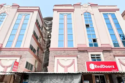 a building with a redoor sign in front of it at Big Bird Palace Ladprao 71 in Bangkok