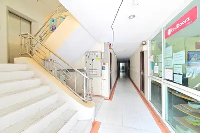 an empty hallway of a hospital with stairs at Big Bird Palace Ladprao 71 in Bangkok