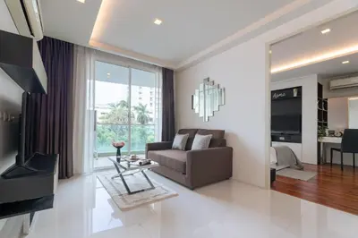 a living room with a couch and a table at Beverly 33 by Aspira in Bangkok