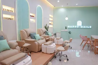 a salon with chairs and a waiting room with happy nails at Mintel Huamark in Bangkok