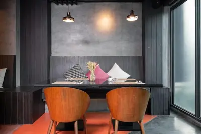 a dining room with a black table and chairs at RakYim Siam - Sukhumvit 15 in Bangkok