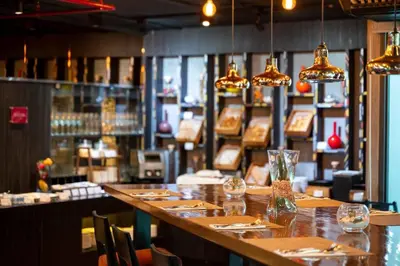 a restaurant with a long bar with tables and chairs at RakYim Siam - Sukhumvit 15 in Bangkok