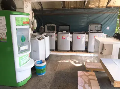 a bunch of machines lined up in a garage at SAM Apartment in Bangkok