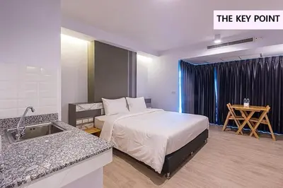 a hotel room with a bed and a sink at The Key Point Hotel in Bangkok