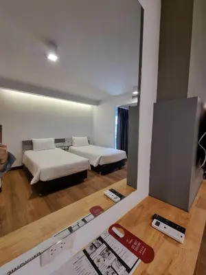 a room with two beds and a tv in it at The Key Point Hotel in Bangkok