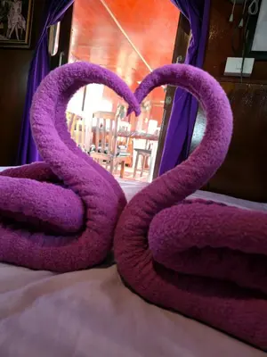 a pair of purple snakes sitting on top of a bed at Sabai Sabai Liveaboard Bangkok in Bangkok