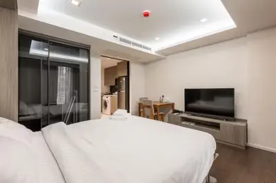 a bedroom with a white bed and a flat screen tv at Circle Rein Sukhumvit 12 #1BR#Pool&Gym#Near Terminal 21#Max2 in Bangkok