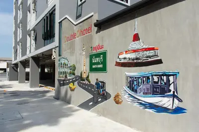 a wall with a painting of a boat on it at โรงแรมดับเบิ้ลดี ปากเกร็ด Double D hotel in Pak Kret