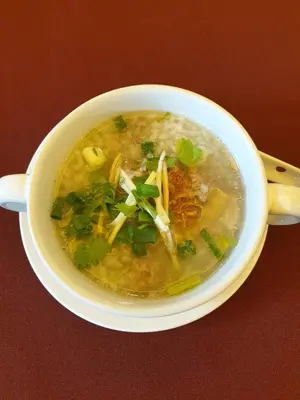 a bowl of soup on a table with a spoon at โรงแรมดับเบิ้ลดี ปากเกร็ด Double D hotel in Pak Kret