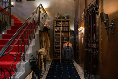 a hallway with a person sitting on a chair in a room at The Coach Hotel Sukhumvit - Asok BTS Bangkok in Bangkok