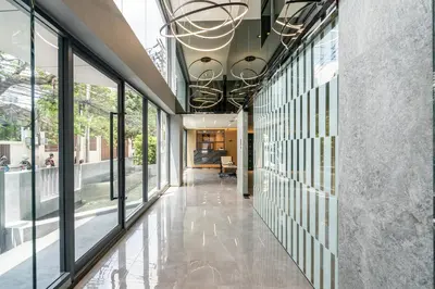 a hallway of a building with large windows at Destiny63 Ekamai Apartment in Bangkok