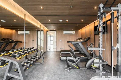 a gym with treadmills and elliptical machines at Destiny63 Ekamai Apartment in Bangkok