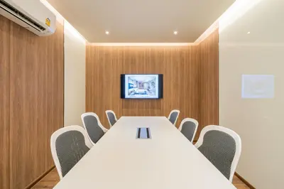 a conference room with a white table and chairs at Destiny63 Ekamai Apartment in Bangkok