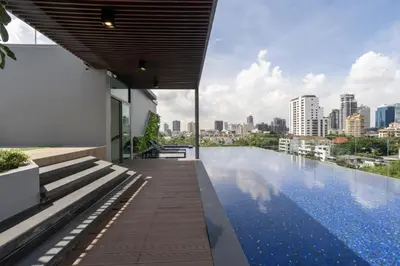 a swimming pool with a city skyline in the background at Destiny63 Ekamai Apartment in Bangkok