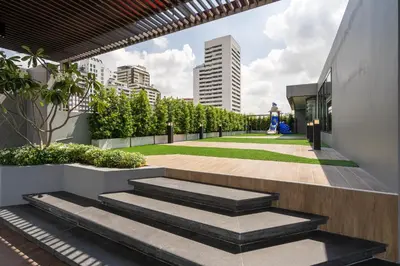 a walkway with stairs leading to a building at Destiny63 Ekamai Apartment in Bangkok