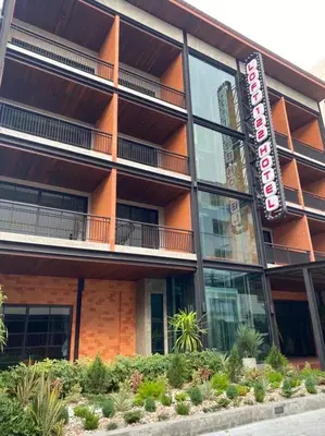 an apartment building with a sign in front of it at Loft122 Hotel in Ban Zong Katiam