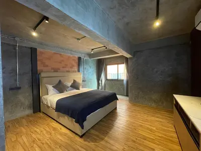 a bedroom with a large bed in a room at Loft122 Hotel in Ban Zong Katiam