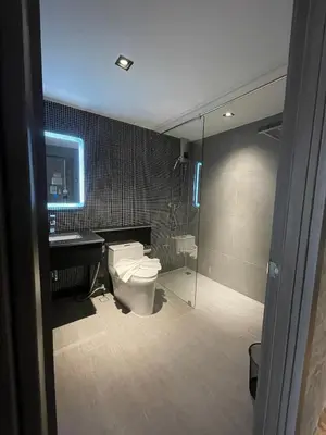 a bathroom with a toilet and a sink and a shower at Loft122 Hotel in Ban Zong Katiam