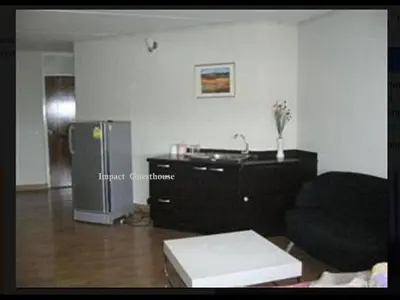 a living room with a couch and a refrigerator at Thailand Taxiapartment Hostel, air conditioning and free Wifi in Thung Si Kan