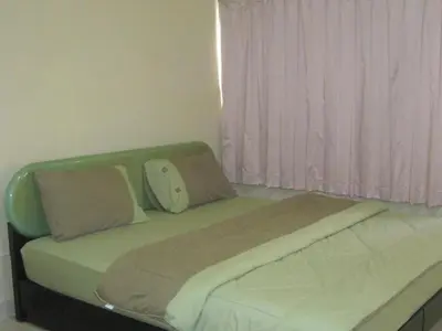 a bed with two pillows on it in a room at Popular Palace in Don Mueang Bangkok in Ban Bang Phang