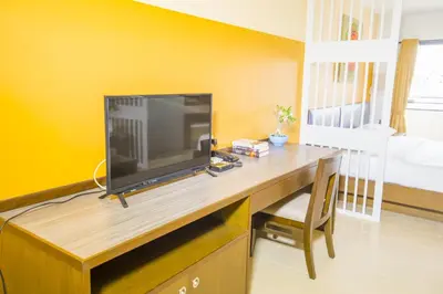 a television sitting on a desk in a room at Sitara Place Serviced Apartment & Hotel in Bangkok