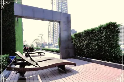 two benches sitting on a deck in a city at Nice Residence in heart of Bangkok in Bangkok