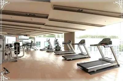 a gym with several treadmills and elliptical machines at Nice Residence in heart of Bangkok in Bangkok