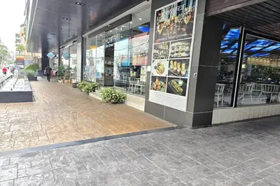 a store front of a building with a brick sidewalk at Nice Residence in heart of Bangkok in Bangkok