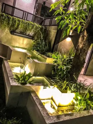 a garden with a water fountain and plants at Exclusive access to the whole garden. in Bangkok