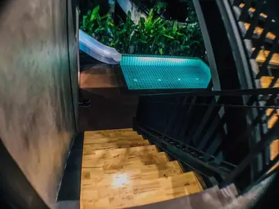 a stairway with a green bench on it at Exclusive access to the whole garden. in Bangkok
