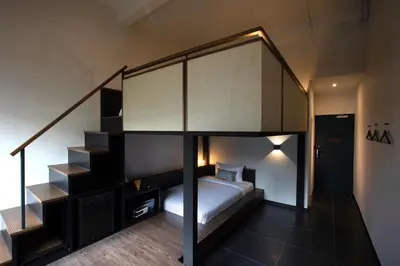 a bedroom with a bunk bed and a staircase at Beanstalk Bangkok in Bangkok