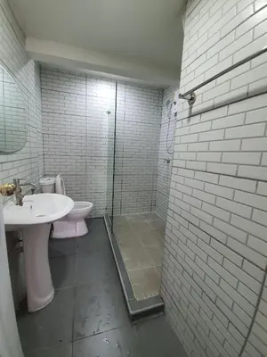 a bathroom with a toilet and a sink and a shower at บ้านอรุณHome in Bangkok