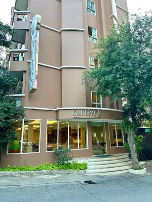 a building with a sign on the front of it at Calypzo Bangkok in Bangkok