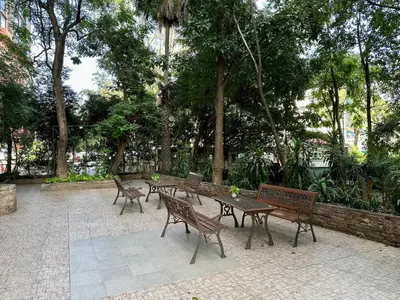 a group of benches and tables in a park at Calypzo Bangkok in Bangkok