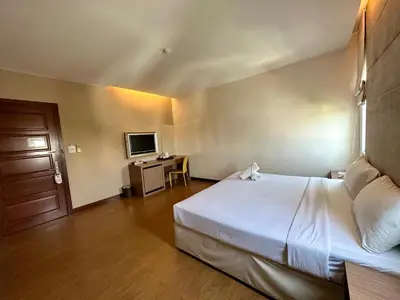 a hotel room with a bed and a television at Calypzo 2 Ratchada 20 in Bangkok