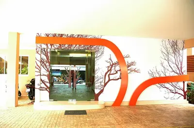 a building with an orange sculpture in front of it at Calypzo 2 Ratchada 20 in Bangkok