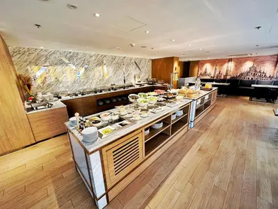 a kitchen with a large island with food on it at Ayathorn Bangkok in Bangkok