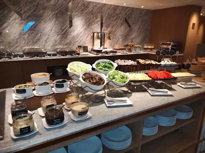 a buffet with many different food items on a table at Ayathorn Bangkok in Bangkok