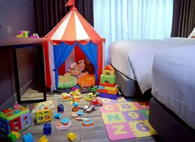 a bedroom with a toy tent and toys on the floor at Ayathorn Bangkok in Bangkok