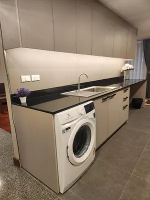 a kitchen with a washing machine and a sink at United Tower Thonglor by Aspira in Bangkok