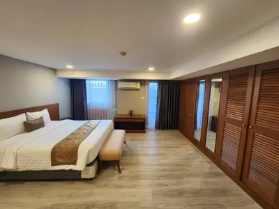 a bedroom with a large bed in a room at United Tower Thonglor by Aspira in Bangkok