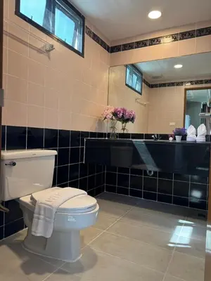 a bathroom with a toilet and a sink at United Tower Thonglor by Aspira in Bangkok