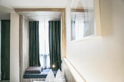 a mirror in a room with a window at HOMITEL Bangkok in Bangkok