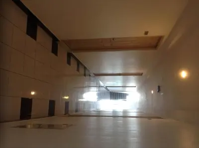 an empty hallway of a building with a light on at Baan Romdee in Nonthaburi