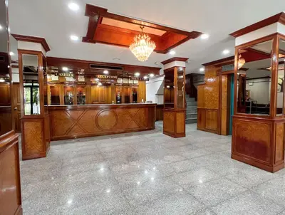 a large room with wood paneling and a chandelier at The Promenade Bangkok in Bangkok